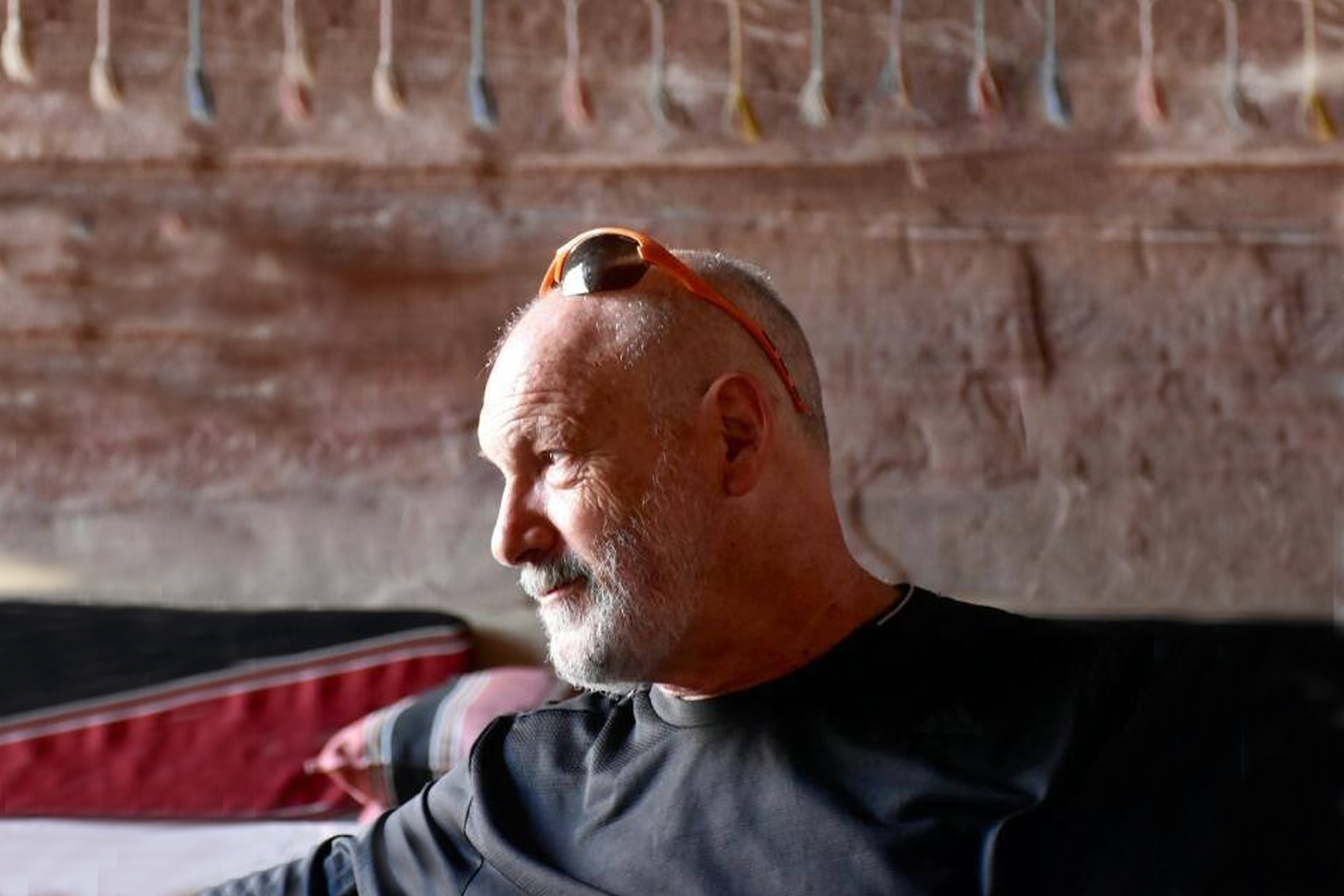 Senior man making notes while speaking with online psychologist